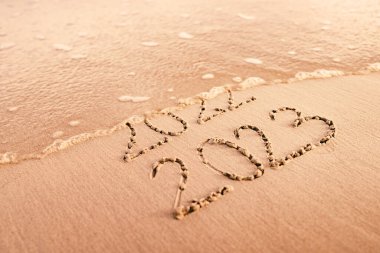 New Year 2023 replace 2022 on the sea beach concept.