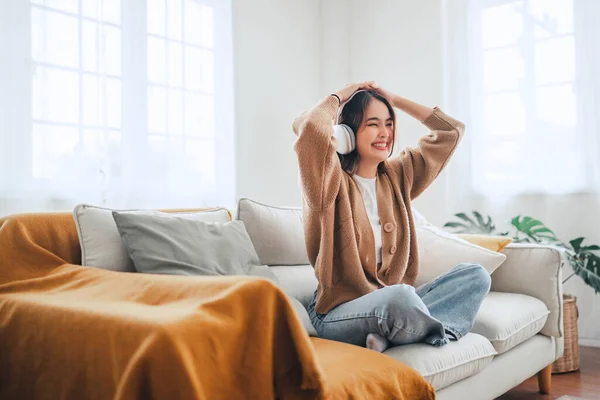 Happy Asian Woman Listening Music Mobile Phone While Sitting Sofa — Foto de Stock