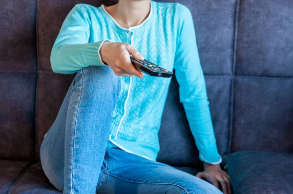 Girl Sitting Couch Remote Her Hand — стоковое фото