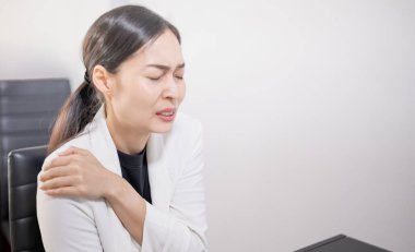 Asian young feeling pain from work, while sitting in front of a laptop in their home. Concept upset stressed employee or student tired of work, worried about the online problem.