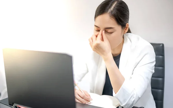 Asian young feeling stressed from work while sitting in front of a laptop in their home. Concept upset stressed employee or student tired of work, worried about the online problem.