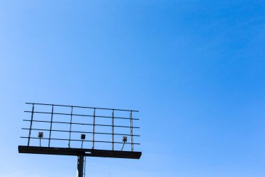empty advertising billboard on blue sky background