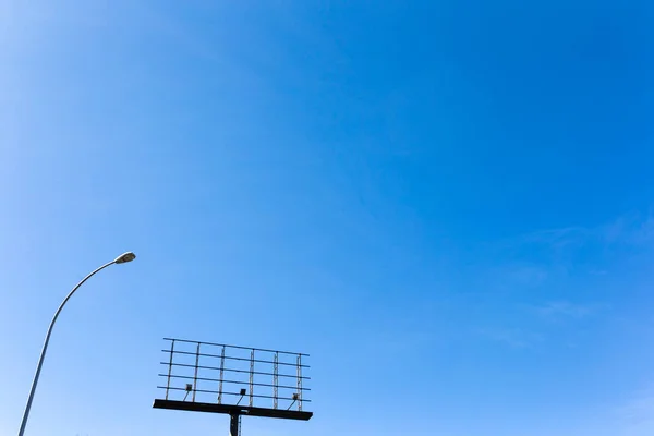 empty advertising billboard on blue sky background