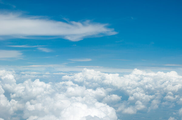 Fluffy white clouds and blue sky background