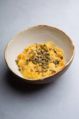 Bir kase ayçiçeği tohumlu sarı mısır lapası.