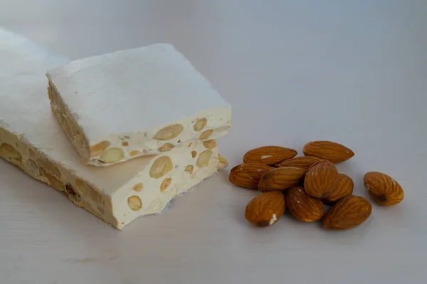 Pieces Hard Nougat Almonds Almonds Next Light Wooden Surface — Stock Fotó