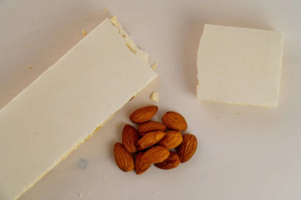 Pieces Hard Nougat Almonds Almonds Next Light Wooden Surface — Stock Fotó