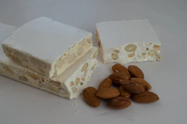 Pieces Hard Nougat Almonds Almonds Next Light Wooden Surface — Stock Fotó