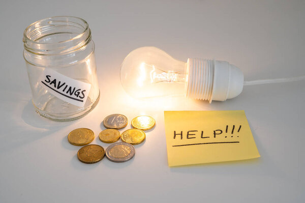 Light bulb on, with coins and empty piggy bank beside it, and a yellow note with the text "help". Increase in electricity bills.