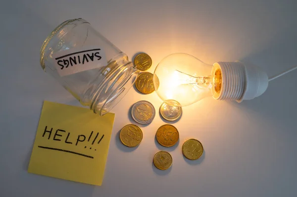 Light bulb on, with coins and empty piggy bank beside it, and a yellow note with the text \