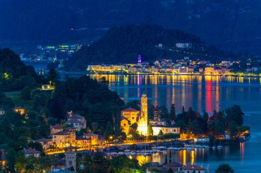 Panorama on Lake Como, with the villages of Tremezzina, Bellagio and the mountains that overlook them, photographed in the evening.