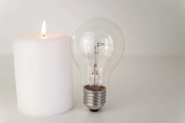 Candle Burning Flame Next Unlit Bulbs Energy Saving Rationing Increase — Φωτογραφία Αρχείου