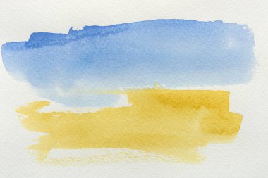 Ukrayna 'nın suluboya bayrağı. Sarı ve mavi renkler. Ülkenin ulusal sembolü. Elle boyanmış renkli dokunuşlar ve suluboya kağıt üzerinde bir fırça. Şık bir pankart ya da arka plan. UA.