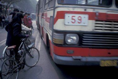 the Bicycle trafic on the mainroad in the city center of Beijing in China.  China, Beijing, October, 1997 clipart