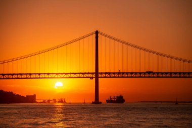 the Ponte 25 de Abril or 25the April Bridge at the Rio Tejo near the City of Lisbon in Portugal.  Portugal, Lisbon, October, 2021