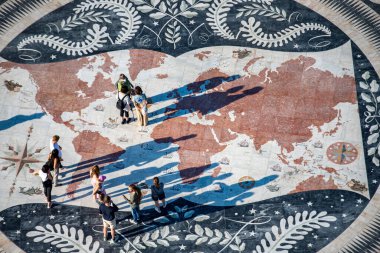 People walk on the giant world Map Mosaic or pavement at the Padrao dos Descobrimentos in Belem near the City of Lisbon in Portugal.  Portugal, Lisbon, October, 2021