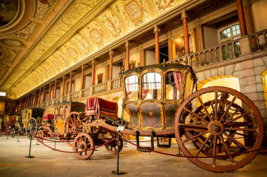 Royal Carrages at the old Building of the Museu National dos coches in the old Royal Riding Hall  in Belem near the City of Lisbon in Portugal.  Portugal, Lisbon, October, 2021