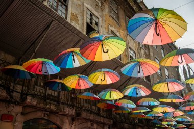 rainbow Umbrellas at the Party Street of Nova do Carvalho in Baixa in the City of Lisbon in Portugal.  Portugal, Lisbon, October, 2021