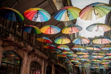 rainbow Umbrellas at the Party Street of Nova do Carvalho in Baixa in the City of Lisbon in Portugal.  Portugal, Lisbon, October, 2021