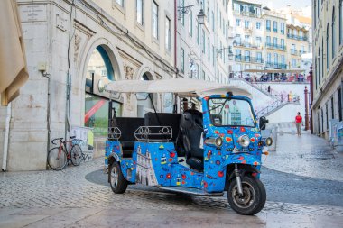 a Tuk Tuk at the Rossia Square in Baixa in the City of Lisbon in Portugal.  Portugal, Lisbon, October, 2021