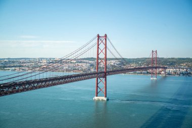 the Ponte 25 de Abril or 25the April Bridge at the Rio Tejo near the City of Lisbon in Portugal.  Portugal, Lisbon, October, 2021