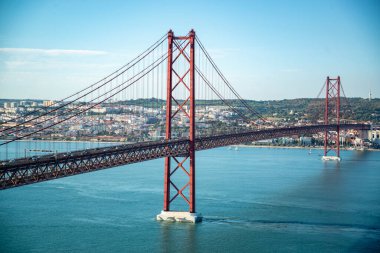 the Ponte 25 de Abril or 25the April Bridge at the Rio Tejo near the City of Lisbon in Portugal.  Portugal, Lisbon, October, 2021