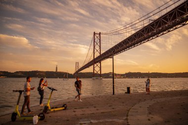 the Ponte 25 de Abril or 25the April Bridge at the Rio Tejo near the City of Lisbon in Portugal.  Portugal, Lisbon, October, 2021