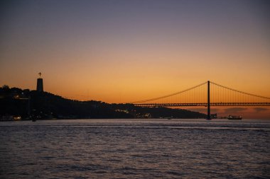 the Ponte 25 de Abril or 25the April Bridge at the Rio Tejo near the City of Lisbon in Portugal.  Portugal, Lisbon, October, 2021
