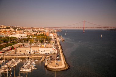 the Doca de Belem or Sailboat Port and the Ponte 25 de Abril at the Rio Tejo in Belem near the City of Lisbon in Portugal.  Portugal, Lisbon, October, 2021