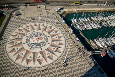 People walk on the giant world Map Mosaic or pavement at the Padrao dos Descobrimentos in Belem near the City of Lisbon in Portugal.  Portugal, Lisbon, October, 2021