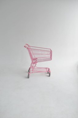 pink shopping trolley isolated on white background
