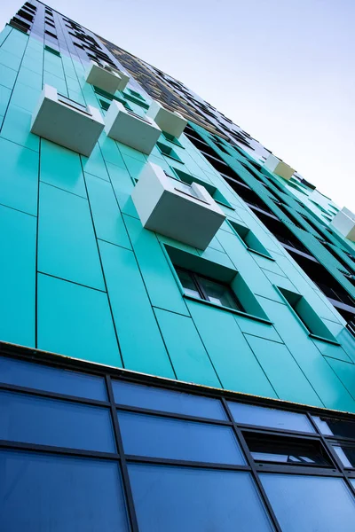 Vista in basso di un edificio moderno a più piani color acqua. giungla urbana — Foto Stock