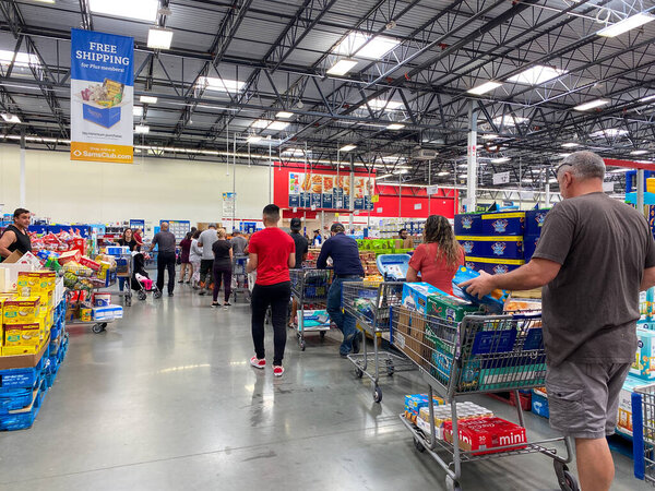 Orlando,FL USA - March 13, 2020:  People waiting in long lines waiting to check out at a Sams Club in Orlando, Florida.