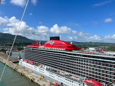 Puerto Plata, DR - January 10, 2022:  The Scarlet Lady a Virgin Voyages Cruise Line cruise ship docked in Puerto Plata, Dominican Republic. clipart
