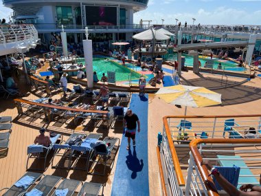 Orlando, FL USA - February 12, 2022:  The Swimming pool area aboard the Royal Caribbean Mariner of the Seas Cruise Ship.
