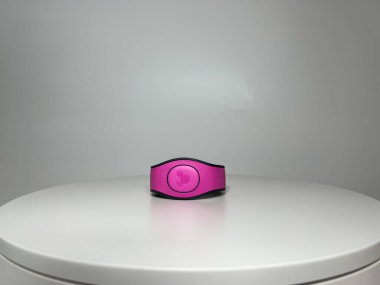 Orlando, FL USA - August 11, 2022:  A pink Magic Band that is used as a ticket to enter Disney World theme parks.
