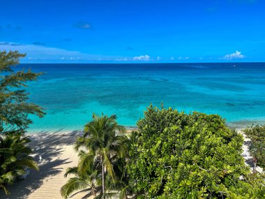 An aerial view of Cemetery Beach on Seven Mile Beach in Grand Cayman Island on a beautiful sunny day.