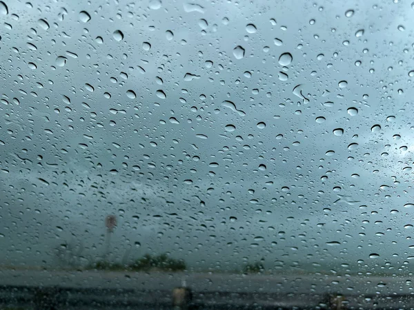 Rain on a car window with a blurred background during a storm in the Florida Keys.