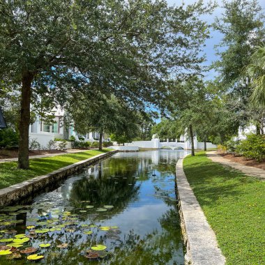 Alys Beach, FL USA - July 26, 2022:  A walking path with water feature and homes in Alys Beach, Florida.