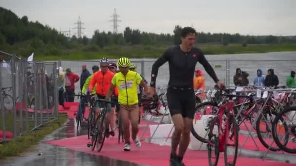 Спортсмены бегают в транзитной зоне на велосипедах — стоковое видео
