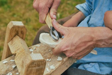 Retro photo. Carpenter carving a spoon close-up. High quality photo