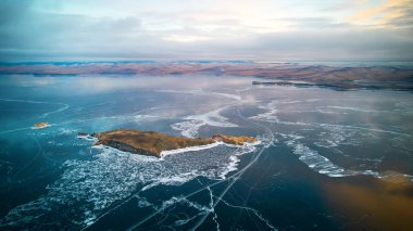 Aerial photography of Lake Baikal in winter. Beautiful view of the frozen lake, clear ice, Oltrek island