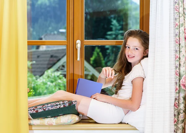 Cute teenage girl siiting on window siil — Stock Photo, Image