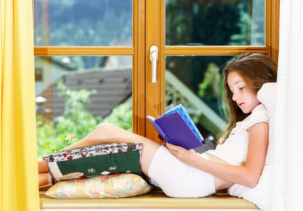 Cute teenage girl siiting on window siil — Stock Photo, Image