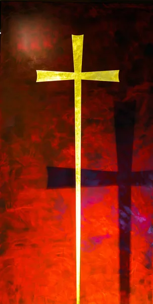 Gold cross on red background — Stock Photo, Image