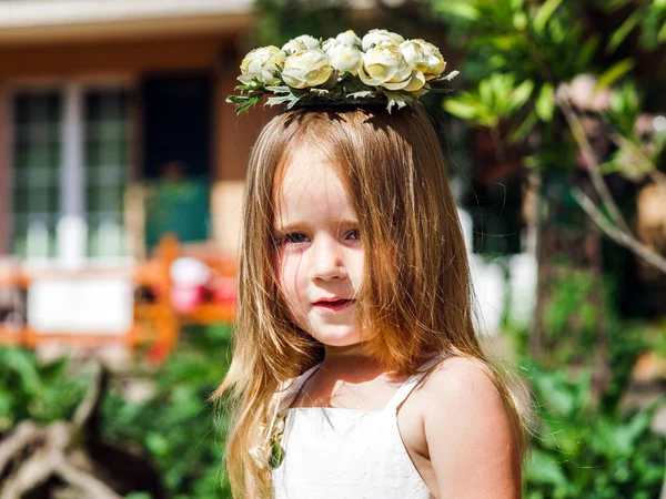 Милая маленькая девочка с цветочным капелланом — стоковое фото