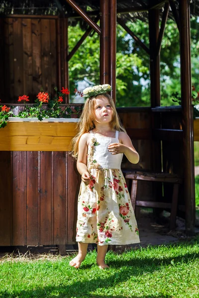 Cute little girl with flowers chaplet — Stock Photo, Image