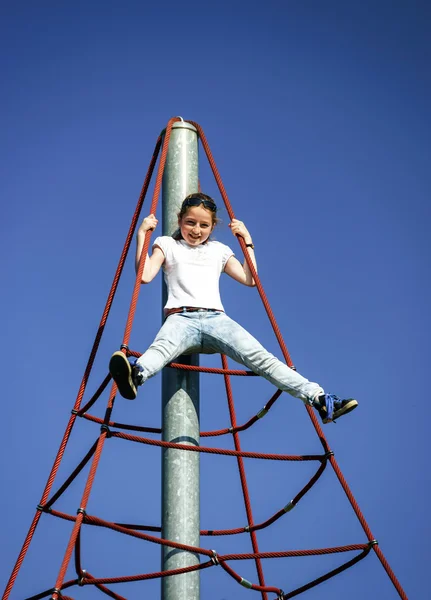 Teenage girl playing on child playground — Stock Photo, Image