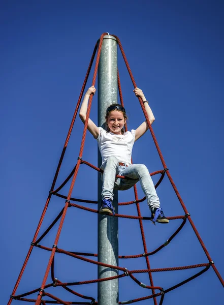 Adolescente jouant sur une aire de jeux pour enfants — Photo