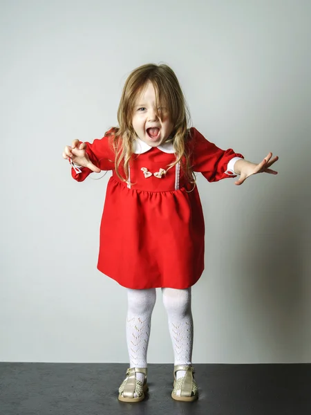 Little girl in red dress frighten photographer — Stock Photo, Image